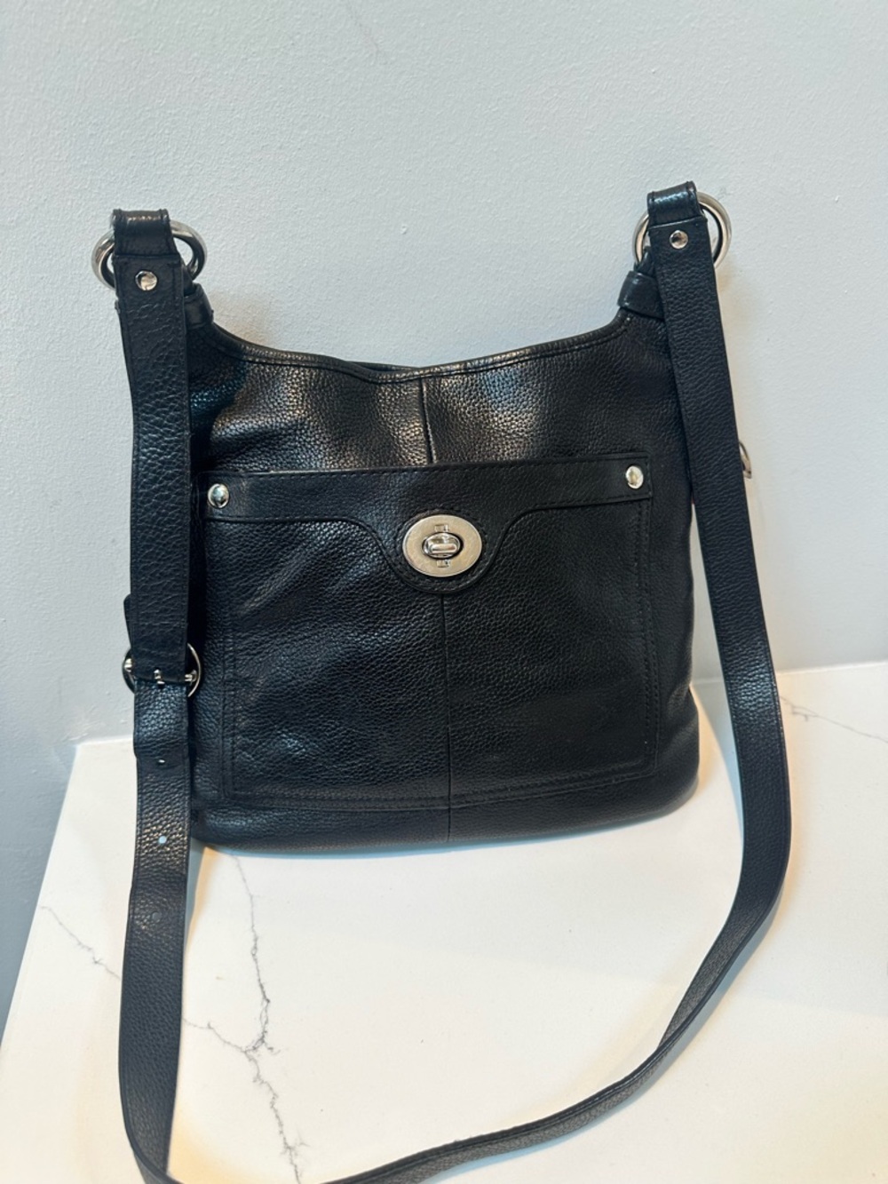 Coach crossbody with Turnlock on pocket with no-brand cherry charm